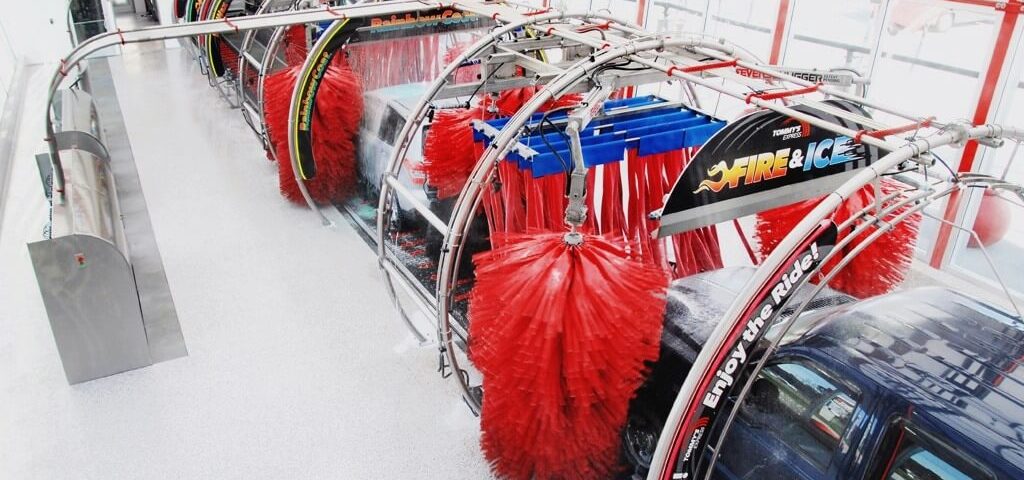 Soft foam brushes cleaning vehicle in wash n go express car wash tunnel showing gentle automated cleaning technology