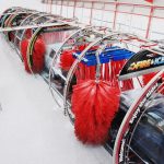Soft foam brushes cleaning vehicle in wash n go express car wash tunnel showing gentle automated cleaning technology