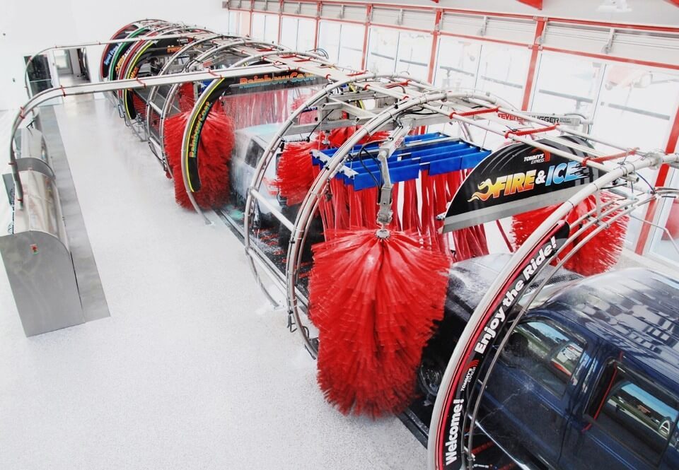 Soft foam brushes cleaning vehicle in wash n go express car wash tunnel showing gentle automated cleaning technology